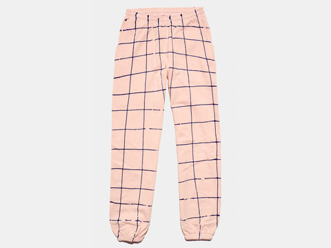 100% cotton pink sweatpants, perfectly cut, with hand-painted, drippy blue grid extending across body and down both legs. Painterly drips perfect the imperfect composition. The pattern continues on the other side of the pants.