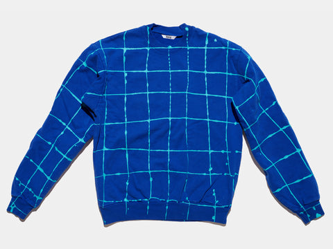 100% cotton blue sweatshirt, perfectly cut, with hand-painted, drippy turqoise grid extending across body and down sleeves. Painterly drips perfect the imperfect composition. The pattern continues on the other side of the shirt.