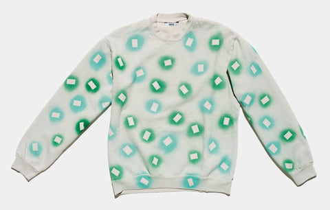 100% cotton grey/cement sweatshirt, perfectly cut, with hand-painted, green and teal negative cut-out squares extending across body and down sleeves. The pattern continues on the other side of the shirt.