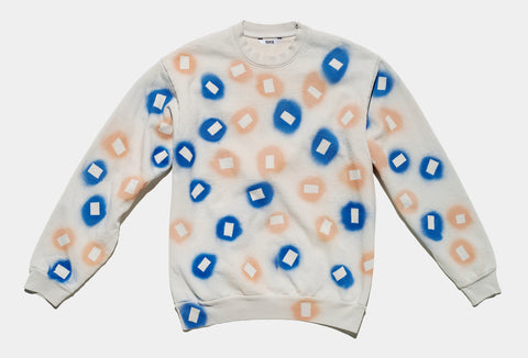 100% cotton grey/cement sweatshirt, perfectly cut, with hand-painted, blue and coral negative cut-out squares extending across body and down sleeves. The pattern continues on the other side of the shirt.
