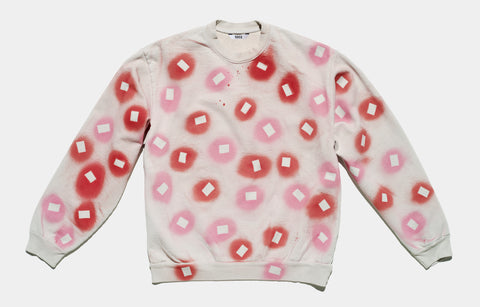 100% cotton grey/cement sweatshirt, perfectly cut, with hand-painted, red and pink negative cut-out squares extending across body and down sleeves. The pattern continues on the other side of the shirt.