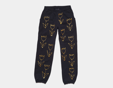 100 % cotton navy sweatpants with a beautiful, lustrous composition of unique, hand-painted gold tulips on the body and down the legs. Composition continues on the other side of the pants.