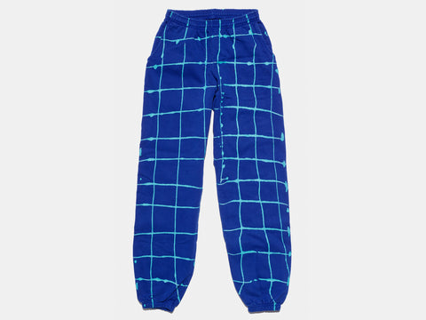 100% cotton blue sweatpants, perfectly cut, with hand-painted, drippy turqoise grid extending across body and down both legs. Painterly drips perfect the imperfect composition. The pattern continues on the other side of the pants. 